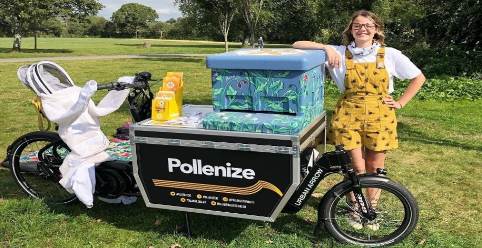 Brittany Clarke, Marketing and Communications Assistant at Pollenize, with their E-cargo bike and decorated beehive in Central park